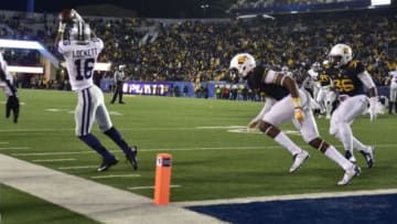 Nov 20, 2014; Morgantown, WV, USA; Kansas State Wildcats wide receiver Tyler Lockett (16) catches the ball as West Virginia Mountaineers cornerback Daryl Worley (7) and linebacker Shaq Petteway (36) defend in the third quarter at Milan Puskar Stadium. Mandatory Credit: Bob Donnan-USA TODAY Sports