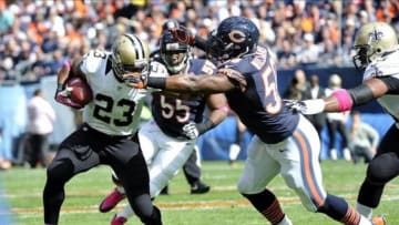 Oct 6, 2013; Chicago, IL, USA; New Orleans Saints running back Pierre Thomas (23) is defended by Chicago Bears middle linebacker D.J. Williams (58) during the first quarter at Soldier Field. Mandatory Credit: Rob Grabowski-USA TODAY Sports