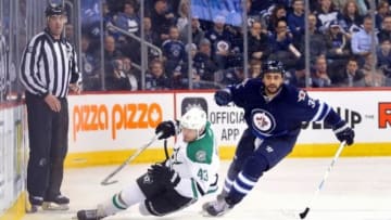 Feb 2, 2016; Winnipeg, Manitoba, CAN; Winnipeg Jets defenseman Dustin Byfuglien (33) chases a loose puck with Dallas Stars right wing Valeri Nichushkin (43) during the third period at MTS Centre. Dallas wins 5-3. Mandatory Credit: Bruce Fedyck-USA TODAY Sports