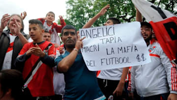 Argentinian River Plate's supporters protest outside the club's stadium in Buenos Aires on December 1, 2018. - River Plate said Saturday they have refused to play the Copa Libertadores final second leg against Boca Juniors in Madrid, casting uncertainty over the December 9 fixture. The match between the Argentine arch-rivals has been moved to Real Madrid's Santiago Bernabeu stadium after it was twice postponed last weekend after River Plate fans attacked the Boca Juniors team bus. (Photo by JAVIER GONZALEZ TOLEDO / AFP) (Photo credit should read JAVIER GONZALEZ TOLEDO/AFP/Getty Images)