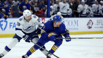 Nov 28, 2022; Buffalo, New York, USA; Tampa Bay Lightning defenseman Ian Cole (28) and Buffalo Sabres center Tyson Jost (17) go after a loose puck during the second period at KeyBank Center. Mandatory Credit: Timothy T. Ludwig-USA TODAY Sports