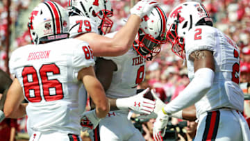 NORMAN, OK - SEPTEMBER 28: Wide receiver T.J. Vasher #9 is congratulated after scoring a touchdown against the Oklahoma Sooners at Gaylord Family Oklahoma Memorial Stadium on September 28, 2019 in Norman, Oklahoma. The Sooners defeated the Red Raiders 55-16. (Photo by Brett Deering/Getty Images)