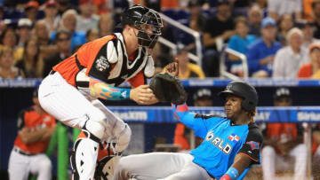 MIAMI, FL - JULY 09: Vladimir Guerrero Jr. #27 of the Toronto Blue Jays and the World Team slides past Zack Collins #8 of the Chicago White Sox and the U.S. Team to score in the seventh inning on a single by Tomas Nido #7 of the New York Mets and the World Team during the SiriusXM All-Star Futures Game at Marlins Park on July 9, 2017 in Miami, Florida. (Photo by Mike Ehrmann/Getty Images)