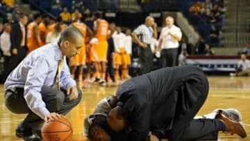 Nov 14, 2014; Annapolis, MD, USA; VCU Rams head coach Shaka Smart (left) watches as medical staff treat guard JeQuan Lewis (1) who hit his head on the floor and would leave the game against the Tennessee Volunteers at United States Naval Academy Alumni Hall. Mandatory Credit: Mitch Stringer-USA TODAY Sports