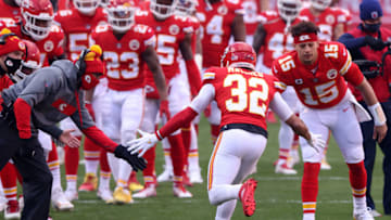 KANSAS CITY, MISSOURI - JANUARY 17: Quarterback Patrick Mahomes #15 of the Kansas City Chiefs welcomes strong safety Tyrann Mathieu #32 onto the field to start the AFC Divisional Playoff game against the Cleveland Browns at Arrowhead Stadium on January 17, 2021 in Kansas City, Missouri. (Photo by Jamie Squire/Getty Images)