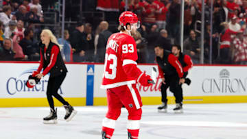 Oct 22, 2023; Detroit, Michigan, USA; Detroit Red Wings right wing Alex DeBrincat (93) skates as ice crew pick up hats from the ice after he scores his third goal of the game in the third period against the Calgary Flames at Little Caesars Arena. Mandatory Credit: Rick Osentoski-USA TODAY Sports