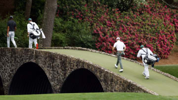 AUGUSTA, GEORGIA - APRIL 10: Tony Finau of the United States and his caddie Mark Urbanek and Justin Thomas of the United States and his caddie, Jimmy Johnson cross the Hogan Bridge during the third round of the Masters at Augusta National Golf Club on April 10, 2021 in Augusta, Georgia. (Photo by Jared C. Tilton/Getty Images)