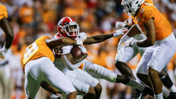 KNOXVILLE, TENNESSEE - OCTOBER 05: Brian Herrien #35 of the Georgia Bulldogs runs with the ball while defended by Nigel Warrior #18 of the Tennessee Volunteers during the fourth quarter at Neyland Stadium on October 05, 2019 in Knoxville, Tennessee. (Photo by Silas Walker/Getty Images)