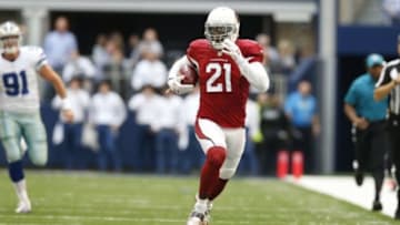 Nov 2, 2014; Arlington, TX, USA; Arizona Cardinals cornerback Patrick Peterson (21) returns a block field goal attempt against the Dallas Cowboys at AT&T Stadium. Mandatory Credit: Matthew Emmons-USA TODAY Sports