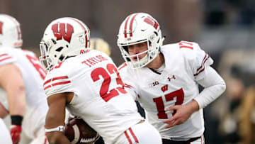 WEST LAFAYETTE, INDIANA - NOVEMBER 17: Jack Coan #17 of the Wisconsin Badgers hands the ball off to Jonathan Taylor #23 in the first quarter against the Purdue Boilermakers at Ross-Ade Stadium on November 17, 2018 in West Lafayette, Indiana. (Photo by Dylan Buell/Getty Images)