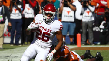 Oct 12, 2019; Dallas, TX, USA; Oklahoma Sooners runnig back Kennedy Brooks (26) runs with the ball in the first quarter against Texas Longhorns safety Chris Brown (15) at the Cotton Bowl. Mandatory Credit: Matthew Emmons-USA TODAY Sports