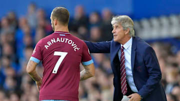 LIVERPOOL, ENGLAND - SEPTEMBER 16: Marko Arnautovic of West Ham United listens to his manager Manuel Pellegrini (R) during the Premier League match between Everton FC and West Ham United at Goodison Park on September 16, 2018 in Liverpool, United Kingdom. (Photo by Arfa Griffiths/West Ham United via Getty Images)