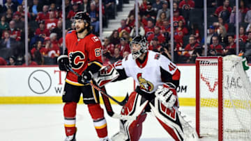 CALGARY, AB - MARCH 21: Ottawa Senators Goalie Craig Anderson (41) pushes Calgary Flames Right Wing Michael Frolik (67) away from his crease during the third period of an NHL game where the Calgary Flames hosted the Ottawa Senators on March 21, 2019, at the Scotiabank Saddledome in Calgary, AB. (Photo by Brett Holmes/Icon Sportswire via Getty Images)