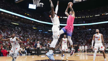 Kyle Kuzma #33 of the Washington Wizards drives to the basket while being defended by Bam Adebayo #13 of the Miami Heat (Photo by Eric Espada/Getty Images)