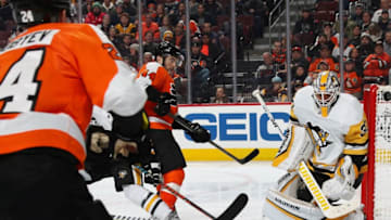 PHILADELPHIA, PA - FEBRUARY 11: Mikhail Vorobyev #24 of the Philadelphia Flyers shoots the puck towards Matt Murray #30 of the Pittsburgh Penguins as Flyer Phil Varone #44 anticipates a rebound on February 11, 2019 at the Wells Fargo Center in Philadelphia, Pennsylvania. (Photo by Len Redkoles/NHLI via Getty Images)