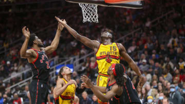 Feb 26, 2022; Atlanta, Georgia, USA; Atlanta Hawks center Clint Capela (15) and Toronto Raptors forward Thaddeus Young (21) reach for a rebound in the second half at State Farm Arena. Mandatory Credit: Brett Davis-USA TODAY Sports