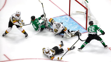 Joel Kiviranta #25 of the Dallas Stars attempts a shot on Robin Lehner #90 of the Vegas Golden Knights as Nick Holden #22 checks Roope Hintz #24 into the goal during the second period in Game Three of the Western Conference Final. (Photo by Bruce Bennett/Getty Images)