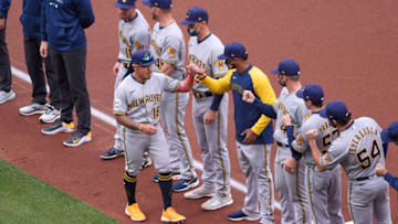 Apr 8, 2021; St. Louis, Missouri, USA; Milwaukee Brewers second baseman Kolten Wong (16) high fives teammates after being introduced during an opening day ceremony prior to a game against the St. Louis Cardinals at Busch Stadium. Mandatory Credit: Joe Puetz-USA TODAY Sports