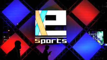 CHIBA, JAPAN - SEPTEMBER 23: People walk past e-Sports logo during the Tokyo Game Show 2017 at Makuhari Messe on September 23, 2017 in Chiba, Japan. (Photo by Ken Ishii/Getty Images for Tokyo Game Show)