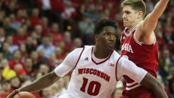 Jan 26, 2016; Madison, WI, USA; Wisconsin Badgers forward Nigel Hayes (10) drives to the basket as Indiana Hoosiers forward Collin Hartman (right) defends at the Kohl Center. Wisconsin defeated Indiana 82-79 (OT). Mandatory Credit: Mary Langenfeld-USA TODAY Sports