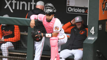 BALTIMORE, MD - MAY 08: Robinson Chirinos #23 of the Baltimore Orioles wearing pink catchers gear for Mothers Day, looks on before game two of a doubleheader baseball game against the Kansas City Royals at Oriole Park at Camden Yards on May 8, 2022 in Baltimore, Maryland. (Photo by Mitchell Layton/Getty Images)