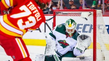 Feb 26, 2022; Calgary, Alberta, CAN; Calgary Flames right wing Tyler Toffoli (73) scores a goal against Minnesota Wild goaltender Kaapo Kahkonen (34) during the first period at Scotiabank Saddledome. Mandatory Credit: Sergei Belski-USA TODAY Sports
