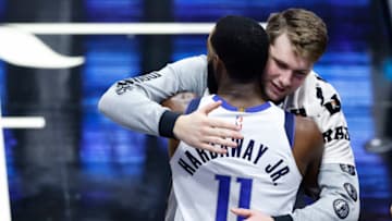 MIAMI, FLORIDA - MAY 04: Luka Doncic #77 of the Dallas Mavericks hugs Tim Hardaway Jr. #11 against the Miami Heat during the fourth quarter at American Airlines Arena on May 04, 2021 in Miami, Florida. NOTE TO USER: User expressly acknowledges and agrees that, by downloading and or using this photograph, User is consenting to the terms and conditions of the Getty Images License Agreement. (Photo by Michael Reaves/Getty Images)