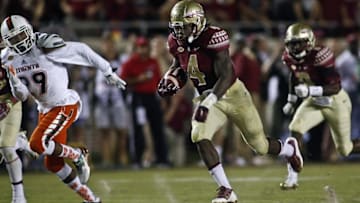 Oct 10, 2015; Tallahassee, FL, USA; Florida State Seminoles running back Dalvin Cook (4) runs for a big gain past Miami Hurricanes defensive back Corn Elder (29) in the second quarter of their game at Doak Campbell Stadium. Mandatory Credit: Phil Sears-USA TODAY Sports