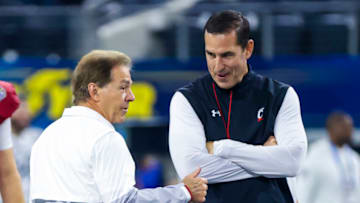 Alabama Crimson Tide head coach Nick Saban speaks with Cincinnati Bearcats head coach Luke Fickell before 2021 Cotton Bowl. USA Today.