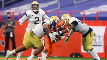 Auburn footballSep 26, 2020; Syracuse, New York, USA; Syracuse Orange running back Sean Tucker (34) is tackled by Georgia Tech Yellow Jackets defensive lineman Jordan Domineck (right) and defensive lineman Djimon Brooks (left) while running with the ball during the third quarter at the Carrier Dome. Mandatory Credit: Rich Barnes-USA TODAY Sports