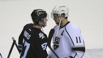 Apr 30, 2014; San Jose, CA, USA; San Jose Sharks center Tommy Wingels (57) shakes hands with Los Angeles Kings center Anze Kopitar (11) after game seven of the first round of the 2014 Stanley Cup Playoffs at SAP Center at San Jose. The Kings defeated the Sharks 5-1. Mandatory Credit: Kyle Terada-USA TODAY Sports