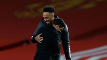 Arsenal's Gabonese striker Pierre-Emerick Aubameyang (L) embraces Arsenal's Spanish manager Mikel Arteta (R) at the end of the English Premier League football match between Manchester United and Arsenal at Old Trafford in Manchester, north west England, on November 1, 2020. (Photo by PHIL NOBLE / POOL / AFP) / RESTRICTED TO EDITORIAL USE. No use with unauthorized audio, video, data, fixture lists, club/league logos or 'live' services. Online in-match use limited to 120 images. An additional 40 images may be used in extra time. No video emulation. Social media in-match use limited to 120 images. An additional 40 images may be used in extra time. No use in betting publications, games or single club/league/player publications. / (Photo by PHIL NOBLE/POOL/AFP via Getty Images)