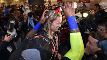 Oct 1, 2016; Philadelphia, PA, USA; New York Mets pitcher Noah Syndergaard (34) is doused by third baseman Jose Reyes (7) after clinching a wild-card playoff berth after a game against the Philadelphia Phillies at Citizens Bank Park. Mandatory Credit: Derik Hamilton-USA TODAY Sports