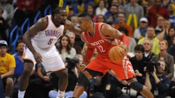 Nov 16, 2014; Oklahoma City, OK, USA; Houston Rockets center Dwight Howard (12) drives to the basket agianst Oklahoma City Thunder center Kendrick Perkins (5) during the third quarter at Chesapeake Energy Arena. Mandatory Credit: Mark D. Smith-USA TODAY Sports