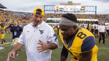Sep 26, 2015; Morgantown, WV, USA; West Virginia assistant coach Joe Deforest (left) talks with West Virginia Mountaineers safety Karl Joseph (right) after beating the Maryland Terrapins at Milan Puskar Stadium. West Virginia won the game 45-6. Mandatory Credit: Ben Queen-USA TODAY Sports