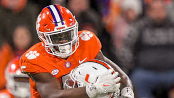 Nov 19, 2022; Clemson, South Carolina, USA; Clemson Tigers defensive end K.J. Henry (5) sacks Miami Hurricanes quarterback Jacurri Brown (11) during the third quarter at Memorial Stadium. Mandatory Credit: Ken Ruinard-USA TODAY Sports