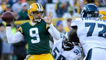 Nov 10, 2013; Green Bay, WI, USA; Green Bay Packers quarterback Seneca Wallace (9) prepares to throw the ball as Philadelphia Eagles linebacker Trent Cole (58) and defensive end Cedric Thornton (72) defend in the first quarter at Lambeau Field. Mandatory Credit: Benny Sieu-USA TODAY Sports