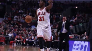 Apr 11, 2014; Chicago, IL, USA; Chicago Bulls guard Jimmy Butler (21) with the ball and Detroit Pistons head coach John Loyer in the background during the first quarter at the United Center. Mandatory Credit: Dennis Wierzbicki-USA TODAY Sports