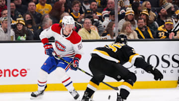 Nov 14, 2021; Boston, Massachusetts, USA; Boston Bruins defenseman Connor Clifton (75) defends Montreal Canadiens left wing Michael Pezzetta (55) during the second period at TD Garden. Mandatory Credit: Paul Rutherford-USA TODAY Sports