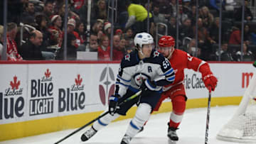 Dec 12, 2019; Detroit, MI, USA; Winnipeg Jets center Mark Scheifele (55) handles the puck as Detroit Red Wings defenseman Filip Hronek (17) defends during the first period at Little Caesars Arena. Mandatory Credit: Tim Fuller-USA TODAY Sports
