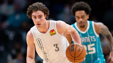 Josh Giddey #3 of the Oklahoma City Thunder brings the ball up court against the Charlotte Hornets during their game at Spectrum Center on January 21, 2022 in Charlotte, North Carolina. NOTE TO USER: User expressly acknowledges and agrees that, by downloading and or using this photograph, User is consenting to the terms and conditions of the Getty Images License Agreement. (Photo by Jacob Kupferman/Getty Images)
