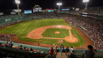 Jul 22, 2021; Boston, Massachusetts, USA; The grounds crew prepares the infield after removing the tarp during the fourth inning in a game between the Boston Red Sox and New York Yankees at Fenway Park. Mandatory Credit: Bob DeChiara-USA TODAY Sports