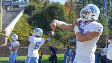 Nov 7, 2020; Durham, North Carolina, USA; North Carolina Tar Heels quarterback Sam Howell (7), quarterback Jacolby Criswell (6), andquarterback Jace Ruder (10) warm up before the start against the Duke Blue Devils at Wallace Wade Stadium. Mandatory Credit: Jim Dedmon-USA TODAY Sports