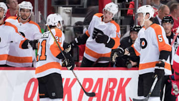 DETROIT, MI - FEBRUARY 03: Scott Laughton #21 of the Philadelphia Flyers pounds gloves with teammates on the bench following his second period goal during an NHL game against the Detroit Red Wings at Little Caesars Arena on February 3, 2020 in Detroit, Michigan. (Photo by Dave Reginek/NHLI via Getty Images)