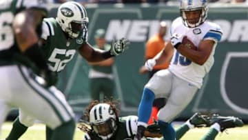 Sep 28, 2014; East Rutherford, NJ, USA; Detroit Lions wide receiver Golden Tate (15) carries the ball as New York Jets inside linebacker David Harris (52) tackles in the second quarter at MetLife Stadium. Mandatory Credit: Noah K. Murray-USA TODAY Sports