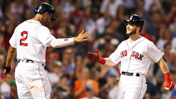 BOSTON, MA - JULY 28: Andrew Benintendi #16 high fives Xander Bogaerts #2 of the Boston Red Sox after hitting a two-run home run in the fourth inning of a game against the New York Yankees at Fenway Park on July 28, 2019 in Boston, Massachusetts. (Photo by Adam Glanzman/Getty Images)