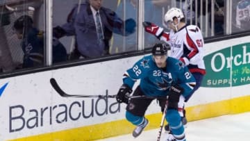 Mar 22, 2014; San Jose, CA, USA; San Jose Sharks defenseman Dan Boyle (22) controls the puck ahead of Washington Capitals center Chris Brown (67) during the first period at SAP Center at San Jose. Mandatory Credit: Kelley L Cox-USA TODAY Sports