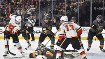 LAS VEGAS, NV - FEBRUARY 21: Alex Tuch #89, Nate Schmidt #88 and Brayden McNabb #3 defend as their teammate goalie Marc-Andre Fleury #29 of the Vegas Golden Knights makes a save against Sean Monahan #23 and Johnny Gaudreau #13 of the Calgary Flames during the game at T-Mobile Arena on February 21, 2018 in Las Vegas, Nevada. (Photo by David Becker/NHLI via Getty Images)
