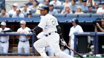Jul 13, 2013; Bronx, NY, USA; New York Yankees second baseman Robinson Cano (24) hits an RBI single against the Minnesota Twins during the first inning at Yankee Stadium. Mandatory Credit: Debby Wong-USA TODAY Sports