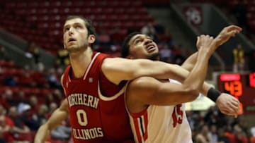 Feb 1, 2014; Muncie, IN, USA; Northern Illinois Huskies center Pete Rakocevic (0) and Ball State Cardinals forward Franko House (15) battle for position during the second half at John E. Worthen Arena. Northern Illinois won 67-65 in OT. Mandatory Credit: Pat Lovell-USA TODAY Sports